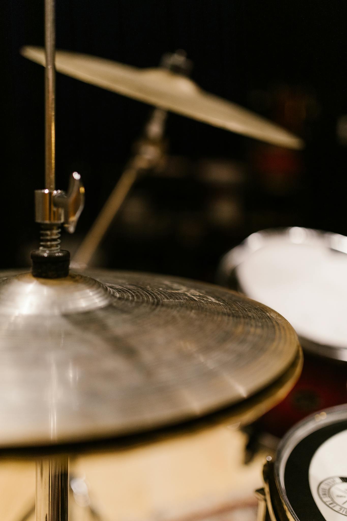 Detailed shot of cymbals on a drum kit in a music studio, showcasing music equipment.